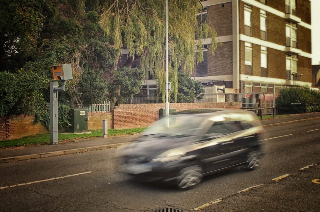 Black car and speed camera