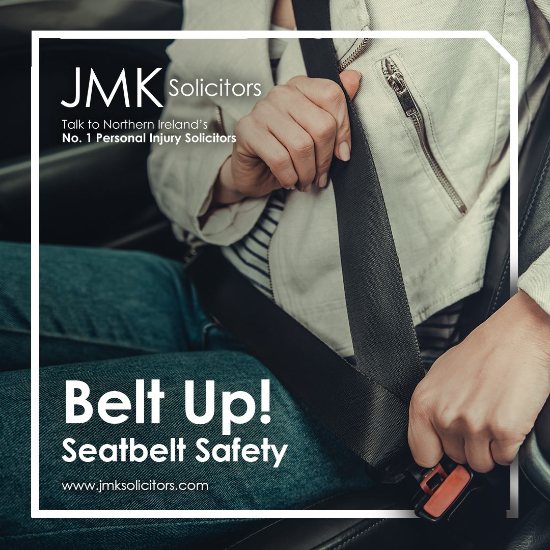 JMK Belt Up graphic. Two people putting on their seat belts in the car