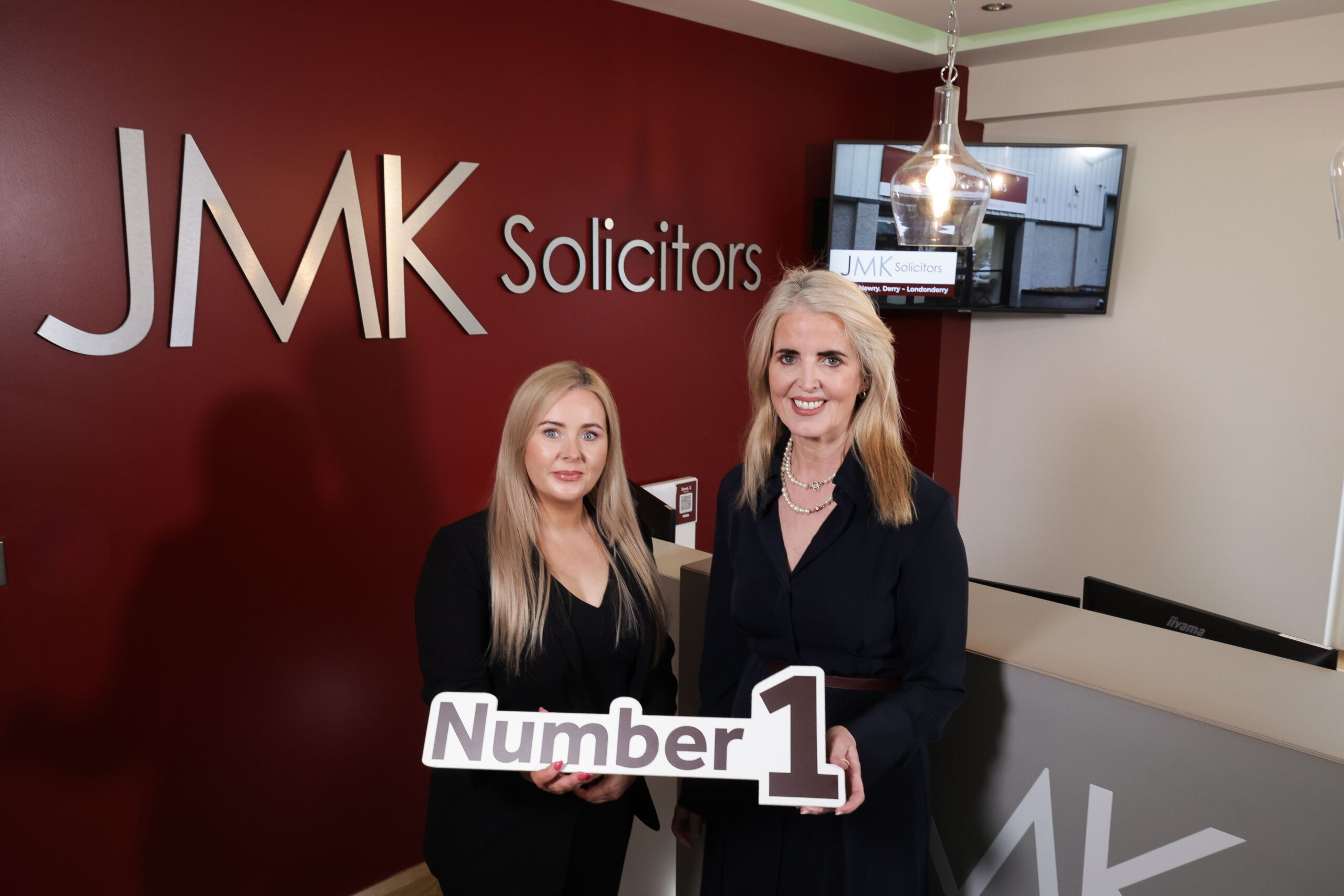 JMK Solicitors leadership team celebrating 12 years as Northern Ireland’s top personal injury law firm.